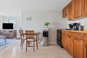 a kitchen with a table and chairs and a refrigerator at Beachside Retreat! Cozy 1-bedroom W Private Yard in Dennis