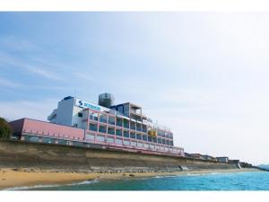 un edificio en la playa junto al agua en Setouchi Resort Hotel - Vacation STAY 95864v, en Matsuyama