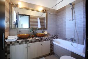 a bathroom with two sinks and a tub and a mirror at dreamOn in Lefkada +25 photos