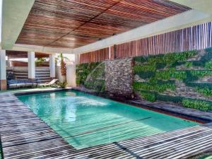 a swimming pool in a house with a retaining wall at Hotel Dial in Guadalupe Victoria