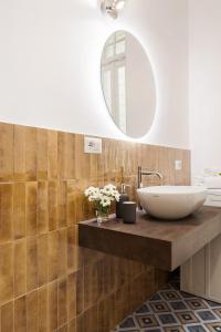 a bathroom with a sink and a mirror at Rome Nice Stays in Rome +32 photos