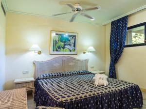 a bedroom with a bed and a ceiling fan at Apartamentos BlueBay Beach Club in San Agustin +19 photos