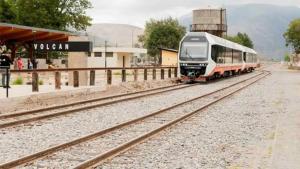 a train on the tracks at a train station at CHAwAY in Volcán