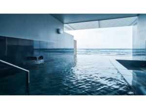 a swimming pool with a view of the ocean at Yunohama Hotel - Vacation STAY 94798v in Hakodate