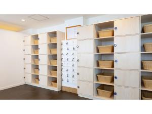 a storage room with white cabinets and shelves at Yunohama Hotel - Vacation STAY 94798v in Hakodate