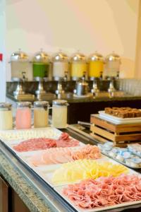 a buffet with many different types of food on display at Hotel Luzeiros Fortaleza in Fortaleza