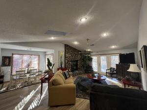 a living room with a couch and a tv at 37CPD, Two bedroom, two bath log-sided condo with forest view condo in Mount Ida