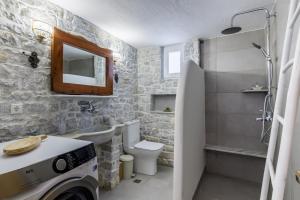 a bathroom with a sink and a toilet and a shower at Amaranthos Village Home in Skopelos Town