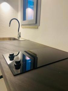 a kitchen counter with a sink and a counter top with a sink at Spanos Apartments in Agios Petros