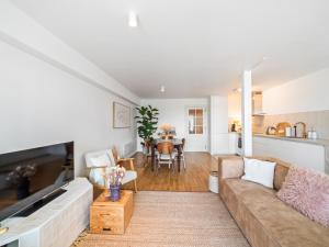 a living room with a couch and a table at Maison Beaufort - uniek zicht op de jachthaven in Ostend