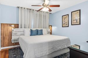 Un dormitorio con una cama blanca con ventilador de techo. en Southbay by the Gulf 010 by Newman-Dailey, en Destin