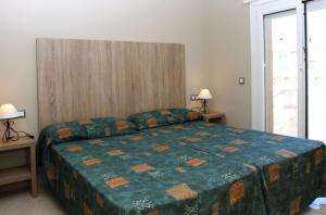 En eller flere senge i et værelse på RVApartaments Provenzal