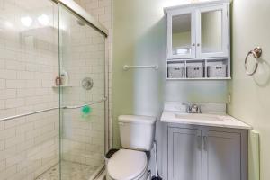 a bathroom with a toilet and a sink and a shower at North Topsail Beach Townhome Walk to the Beach! in North Topsail Beach +29 photos