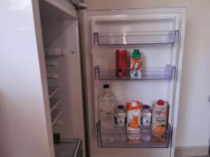 an open refrigerator filled with drinks and drinks at Harmony beach house in Roda
