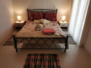 a bedroom with a large bed with two tables and two lamps at Harmony beach house in Roda