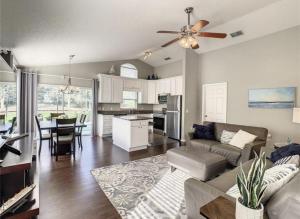 a kitchen and living room with a couch and a ceiling fan at Updated Private Pool Villa - Southern Dunes in Haines City