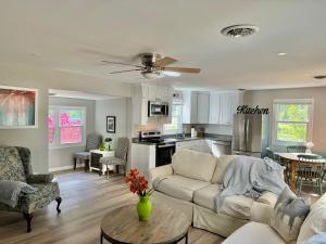 a living room with a white couch and a kitchen at Holly Hill Haven in Edgewater