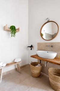 a bathroom with a sink and a mirror at U'Marranzanu Exclusive Relais in Noto +57 photos