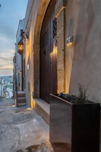 a building with a door and a planter on a street at U'Marranzanu Exclusive Relais in Noto