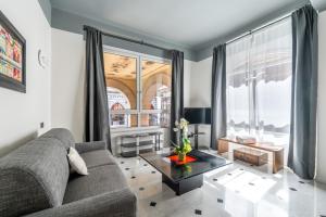 a living room with a couch and a large window at Giada Home Luxury in Genova City Centre in Genova