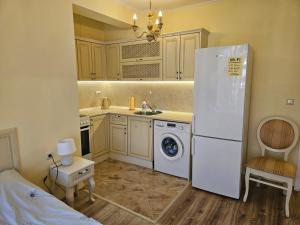 a kitchen with a white refrigerator and a sink at Apartments Anna on the Sunny beach in Sunny Beach