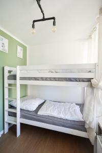 two bunk beds in a room with green walls at Sternenblick Lodge, im Harz, mit Schwimmbad und Sauna in Braunlage