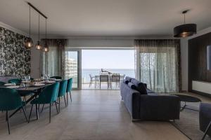a living room with a couch and a table and chairs at 602 Sliema 3bed Seafront With Pool By Homely in Sliema