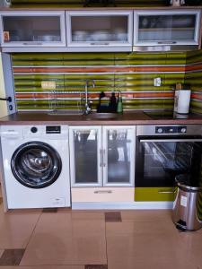 a kitchen with a washing machine and a sink at The View Apartment in Plovdiv +11 photos