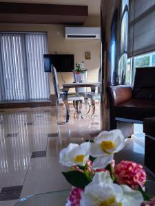 a living room with a couch and a table with flowers at The View Apartment in Plovdiv
