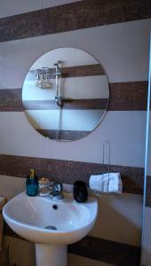 a bathroom with a white sink and a mirror at The View Apartment in Plovdiv