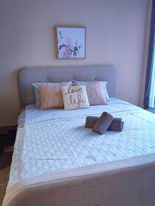 a large bed with a love sign on it at The View Apartment in Plovdiv
