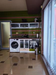a kitchen with a stove and a washing machine at The View Apartment in Plovdiv