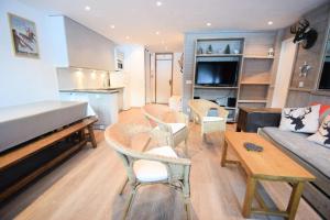 a living room with a couch and chairs and a table at Résidence Le Makalu - 4 Pièces 8/9 pers - LE MAKALU -034MA- PLAGNE CENTRE - WIFI MAE-5964 in Aime La Plagne