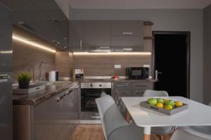 a kitchen with a table with a bowl of fruit on it at Marina Bay Apartmant in Pomorie