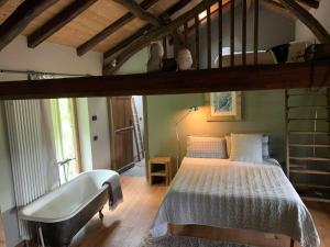 a bedroom with a bed and a tub in a room at Affittacamere Montagne Verdi in Varallo