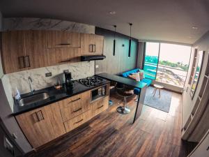 an overhead view of a kitchen with wooden cabinets at Santorini Apartamentos Amoblados in Pereira