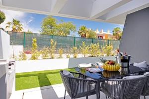 a table with a bowl of fruit on it on a balcony at One Six Villa in Vilamoura