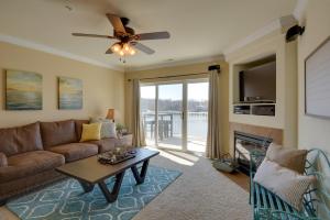 a living room with a couch and a ceiling fan at Lake Views and Pool Access Osage Beach Condo in Osage Beach