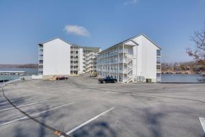 a parking lot in front of a large building at Lake Views and Pool Access Osage Beach Condo in Osage Beach