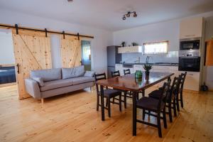 a living room with a table and a couch at Alpakavendégház in Balatoncsicsó