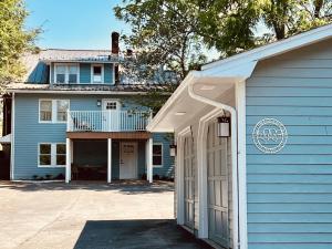 a blue house with a porch and a garage at The Barter Green Room in Abingdon