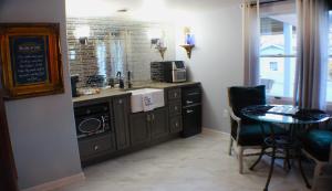 a kitchen with a sink and a table with a microwave at The Barter Green Room in Abingdon