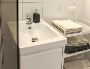 a bathroom with a white sink and a mirror at Külaliskorter Kärdlas in Kärdla +13 photos