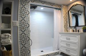 a bathroom with a shower with a sink and a mirror at The Barter Green Room in Abingdon