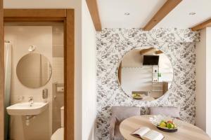 a bathroom with a table and a mirror and a sink at Vila Epušė in Palanga +100 photos