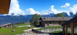 an old stone building with mountains in the background at Cuckoo Apartment in Pila