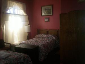 a red bedroom with two beds and a window at Ubon Thai Victorian Inn & Restaurant in Staunton
