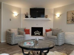 a living room with a table and a fireplace at Endless Beach #B,Oceanfront, 3bedrooms-2bath-Pet Friendly in Virginia Beach