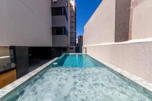 a swimming pool on the roof of a building at Top Unique Maceió in Maceió