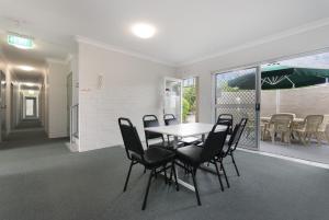 a dining room with a table and chairs at Herston Place Motel in Brisbane